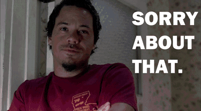 a man wearing a maroon shirt with the words sorry about that on the bottom