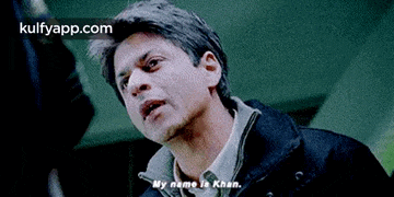 a man in a black jacket is talking to someone .