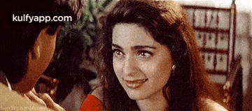 a man and a woman are looking at each other .