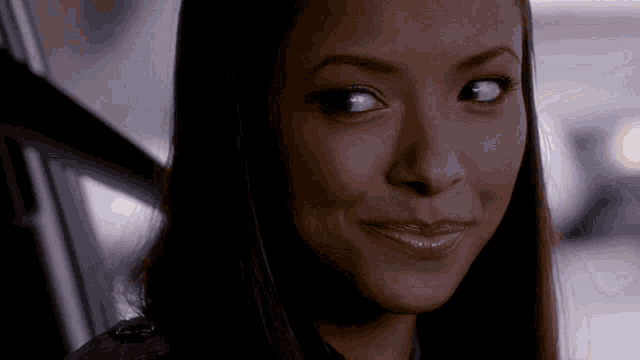 a close up of a woman 's face with a slight smile on her face