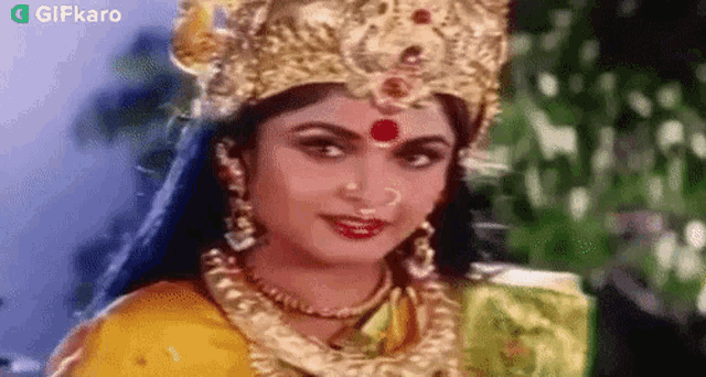 a close up of a woman wearing a crown and necklace .