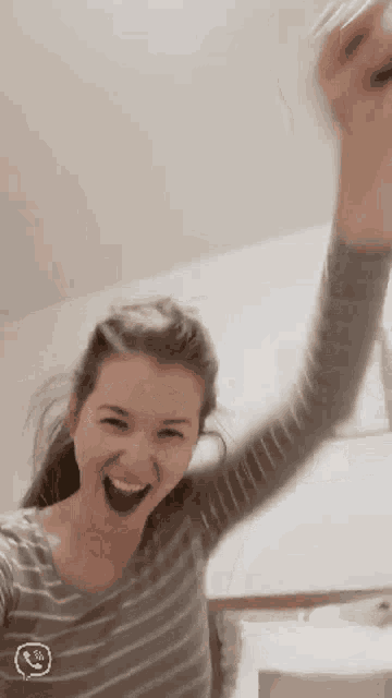 a girl in a striped shirt with a smiley face on her chest