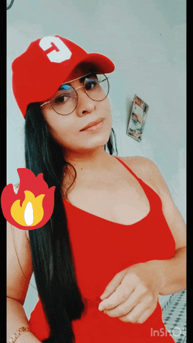 a woman wearing a red top and a red hat with the letter t on it