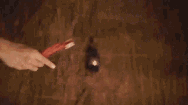 a close up of a person 's hand in a dark room .