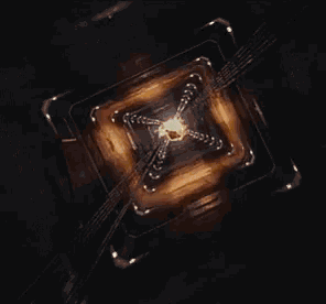 an aerial view of a nuclear explosion in a dark room with smoke coming out of it .
