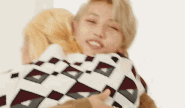 a man is holding a woman in his arms and they are hugging each other and smiling .