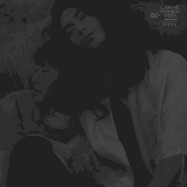 a black and white photo of a man and woman with lakme fashion week written on the bottom
