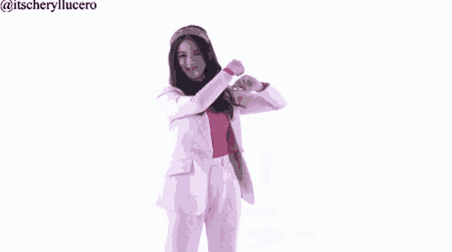 a woman in a pink suit is dancing on a white background