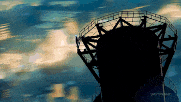 a silhouette of a person standing on top of a tower with the words sayonarc below