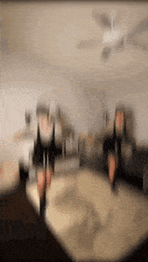 a blurry picture of a person dancing in a living room