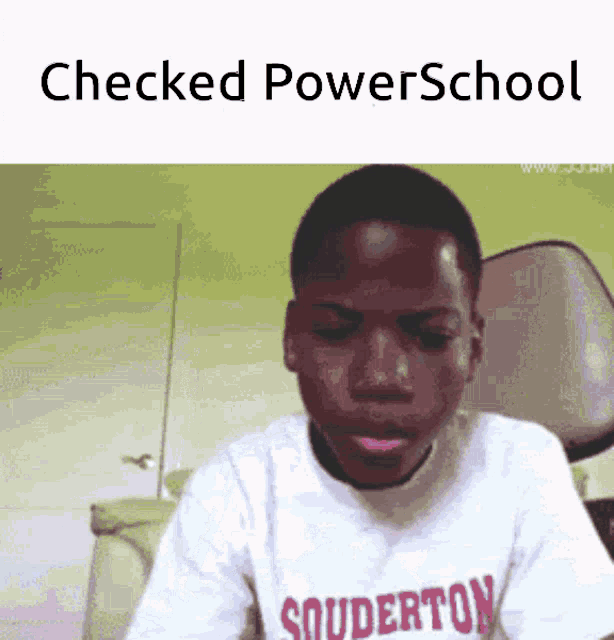 a boy wearing a shirt that says souderton looks at the camera