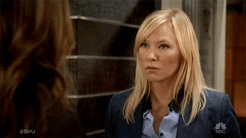 a woman in a blue suit is talking to another woman with the nbc logo on her jacket