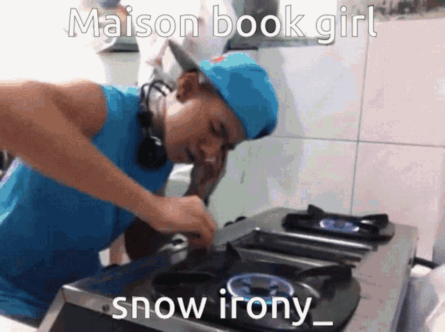 a man wearing a blue hat is cooking on a stove with the caption maison book girl snow irony