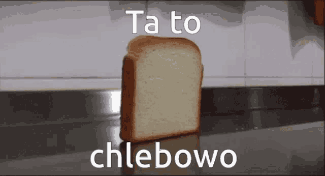 a loaf of bread is sitting on a counter with the words ta to chlebowo above it