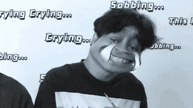 a black and white photo of a man with the words " crying " on the wall behind him