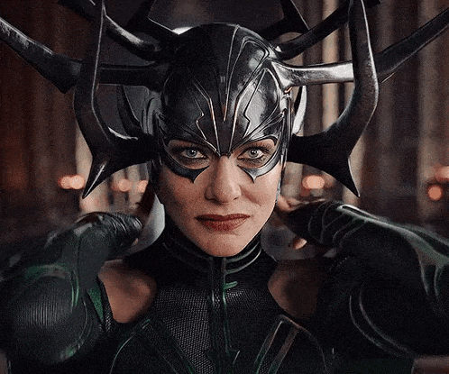 a close up of a woman wearing a helmet with horns on it