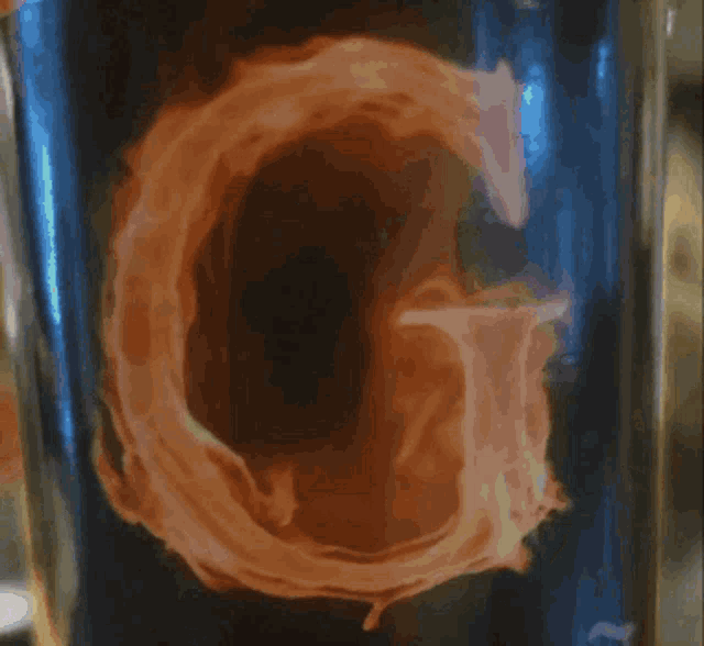 a blurred image of a glass with a purple flower on the side