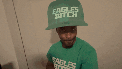 a man wearing a hat that says eagles bitch on it