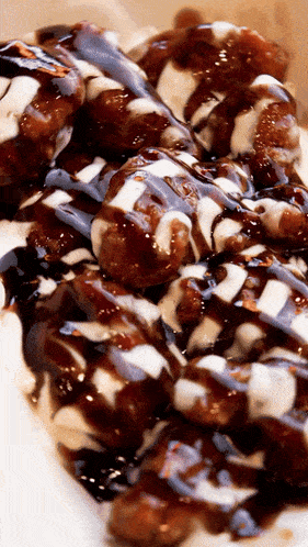a close up of a plate of food with sauce and a white sauce