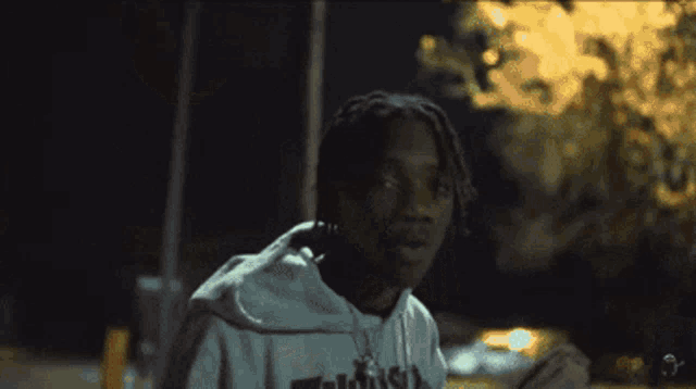 a person wearing a thrasher sweatshirt is holding a bunch of money