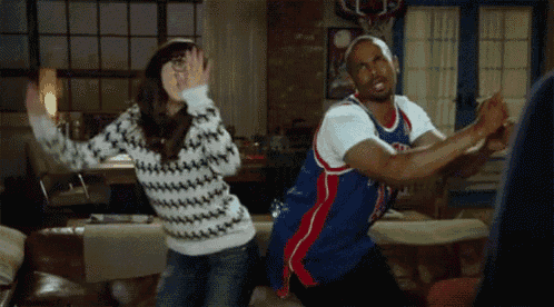 a man and a woman are dancing in a living room