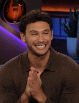 a man in a brown shirt is clapping his hands
