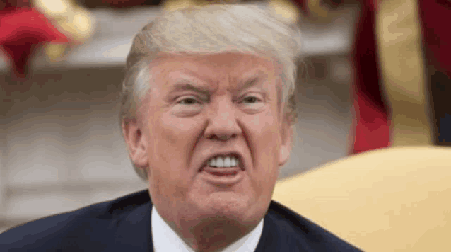 donald trump is making a funny face with his mouth open and his teeth showing .