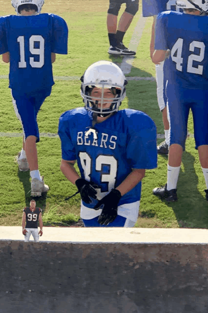 a football player wearing a bears jersey stands on a field