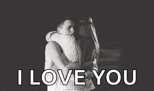 a man and a woman hugging each other in a black and white photo with the words `` i love you '' .