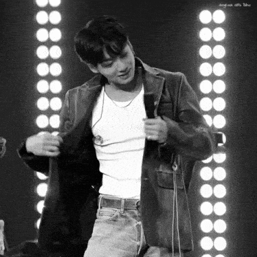a black and white photo of a man in a white tank top