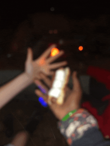 a blurry photo of a person holding a lighter