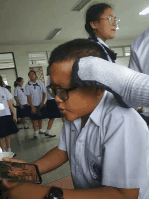 a boy wearing glasses and a shirt that says ' a ' on the front