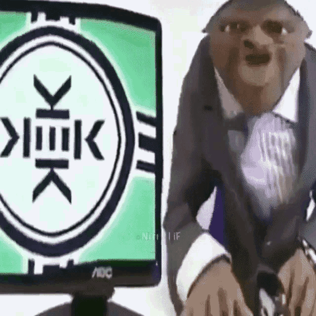 a cartoon character sitting in front of an aoc monitor