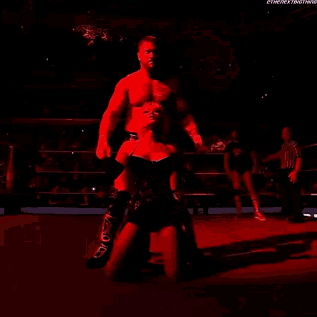 a poster for karrion kross with scarlett shows a man and woman in a wrestling ring