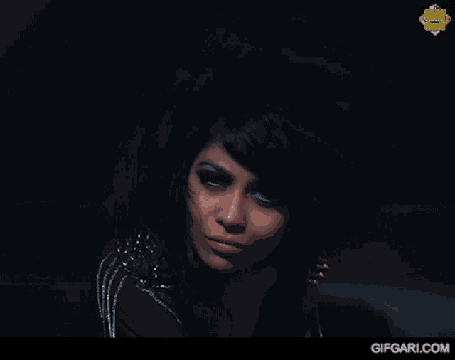 a close up of a woman 's face with a gifgari.com logo in the background