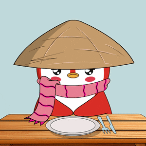 a penguin wearing a hat and scarf sits at a table with a plate and fork