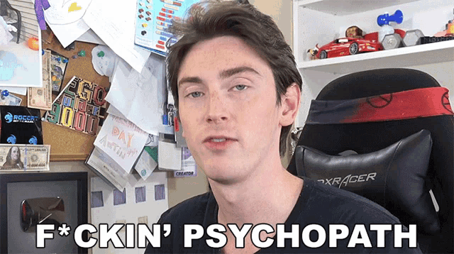 a man says f * ckin ' psychopath in front of a desk