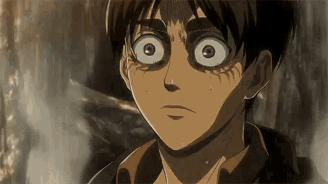 a close up of a person 's face with a shocked look on their face .
