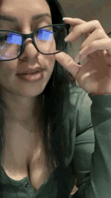 a woman wearing glasses with a blue reflection on the lenses