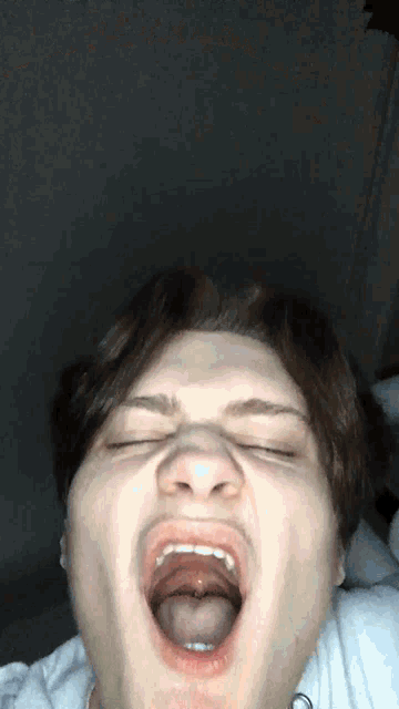 a man with his eyes closed and his tongue hanging out