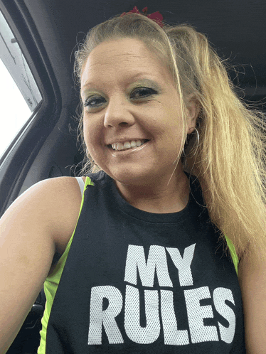 a woman wearing a shirt that says my rules smiles for the camera
