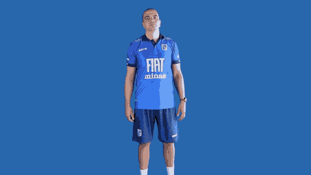 a man wearing a blue shirt with fiat minas on it