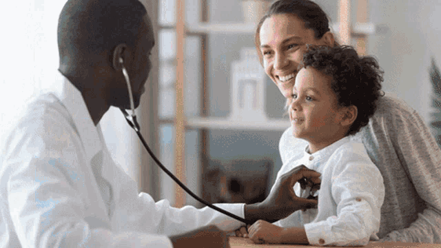 a doctor examines a child with a stethoscope while his mother looks on