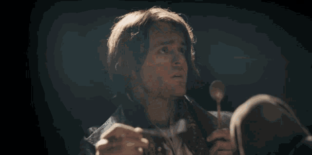 a man with red hair is holding a microphone and saying " rude "