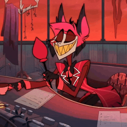 a cartoon character is sitting at a desk and smiling