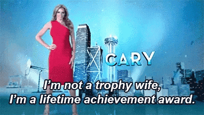 a woman in a red dress is standing in front of a city skyline and says i 'm not a trophy wife