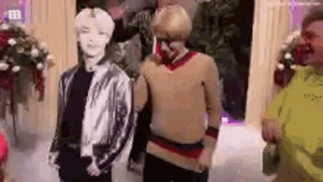 a group of people are standing next to each other in a room and dancing .