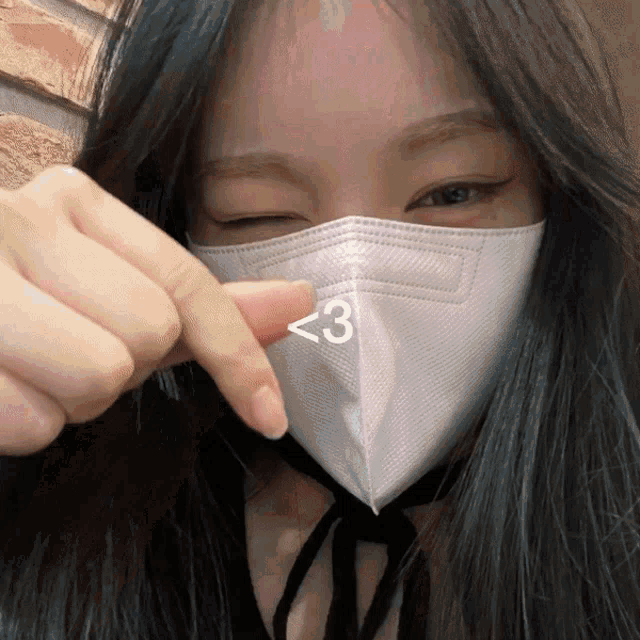a woman wearing a face mask has the number 3 on her nose