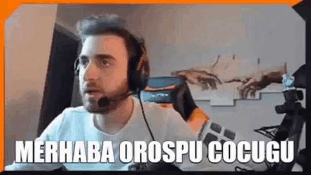 a man wearing a headset is sitting in front of a computer .