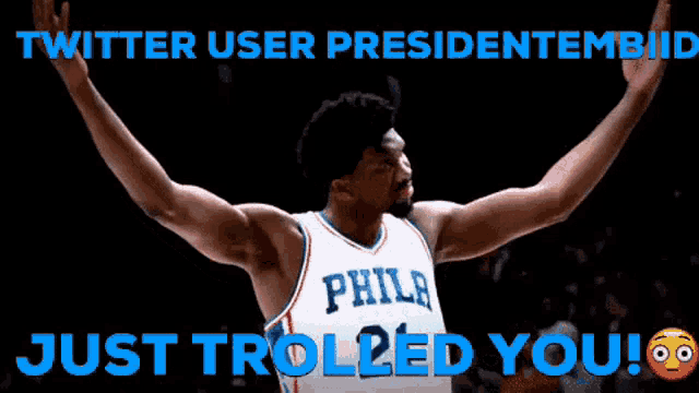 a philadelphia basketball player has his arms outstretched in celebration